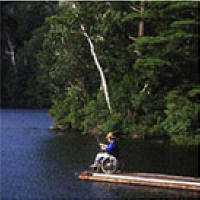 photo of man in wheelchair fishing from floating
pier