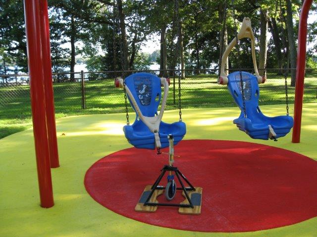 Two hard-back swings over a hybrid outdoor carpet surface system.