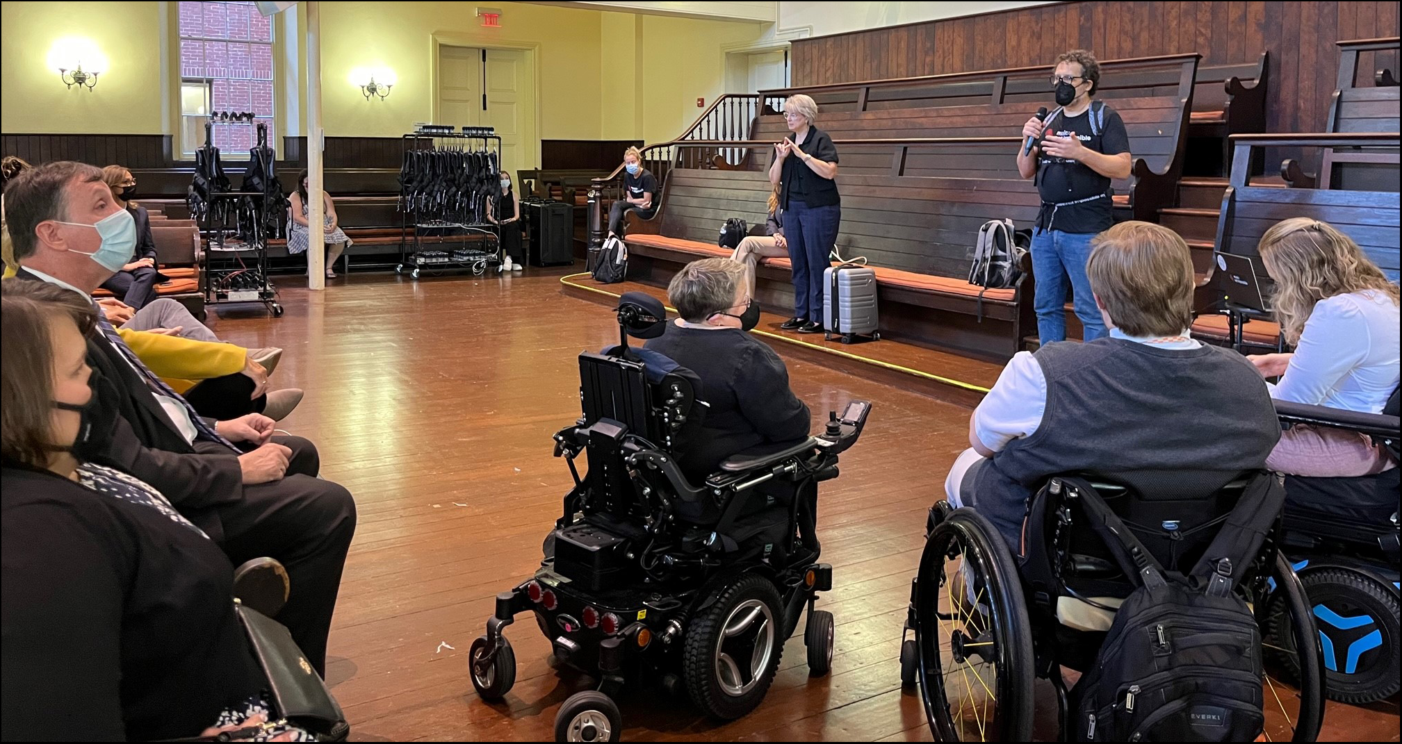 Board members listen to Daniel Belquer of Music: Not Impossible speaking