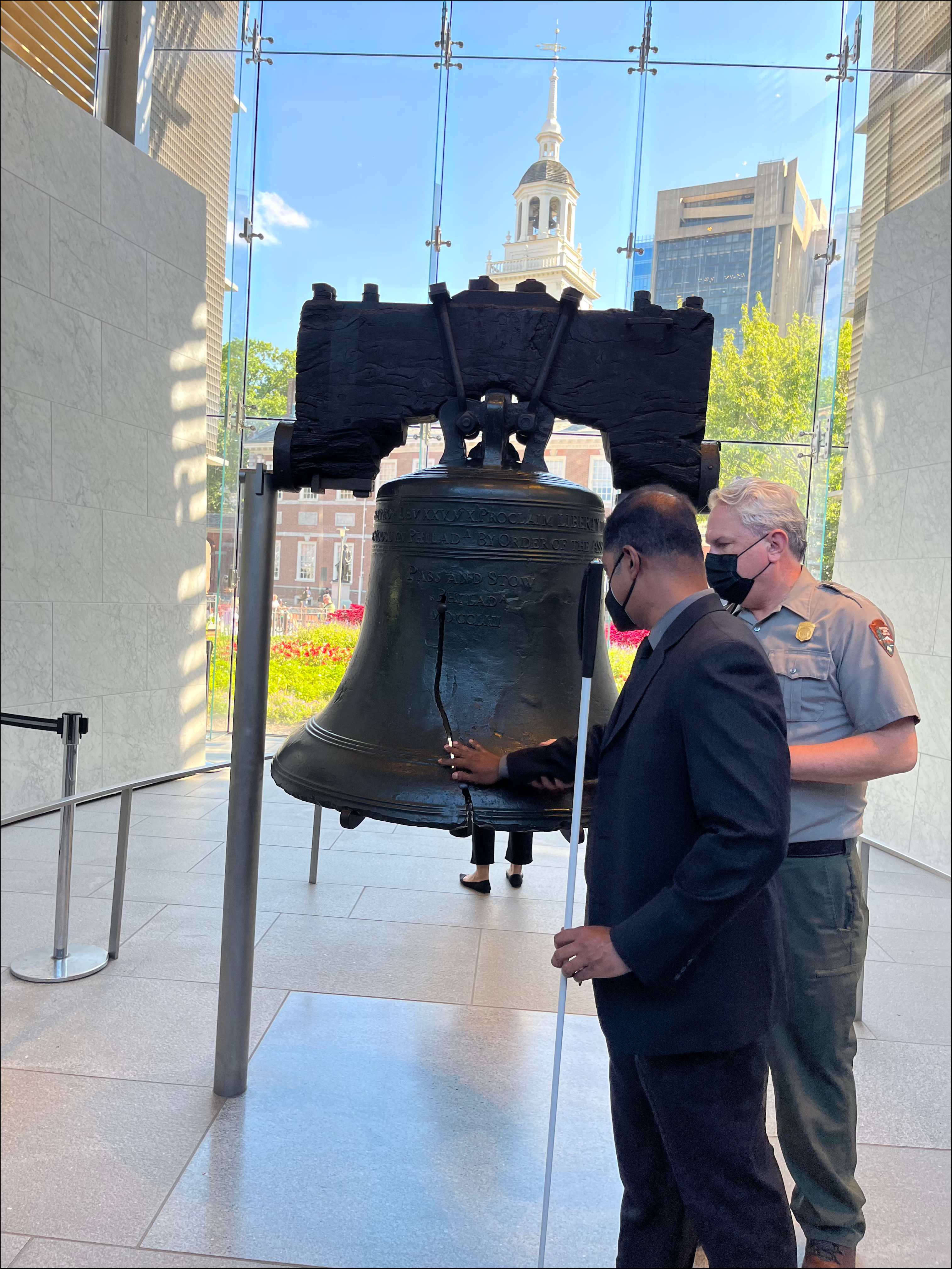 Executive Director Sachin Pavithran touching the liberty bell