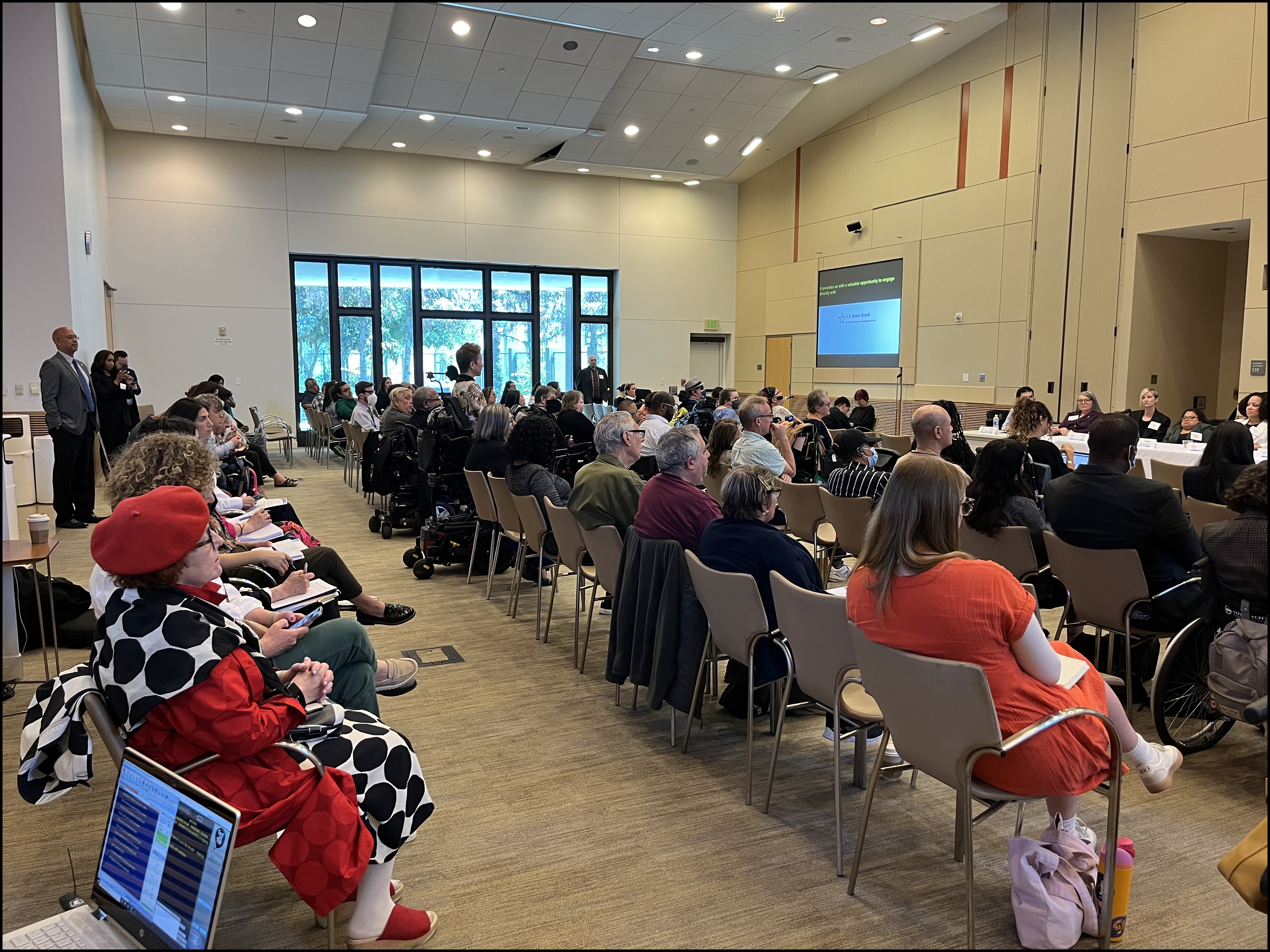 Over 100 attendees sit in rows while in attendance at the town hall.